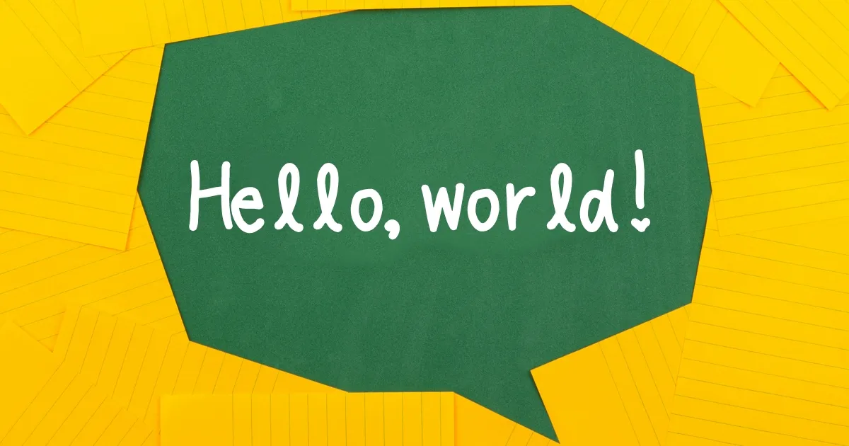 A speech bubble made of sticky notes says "Hello, world!"